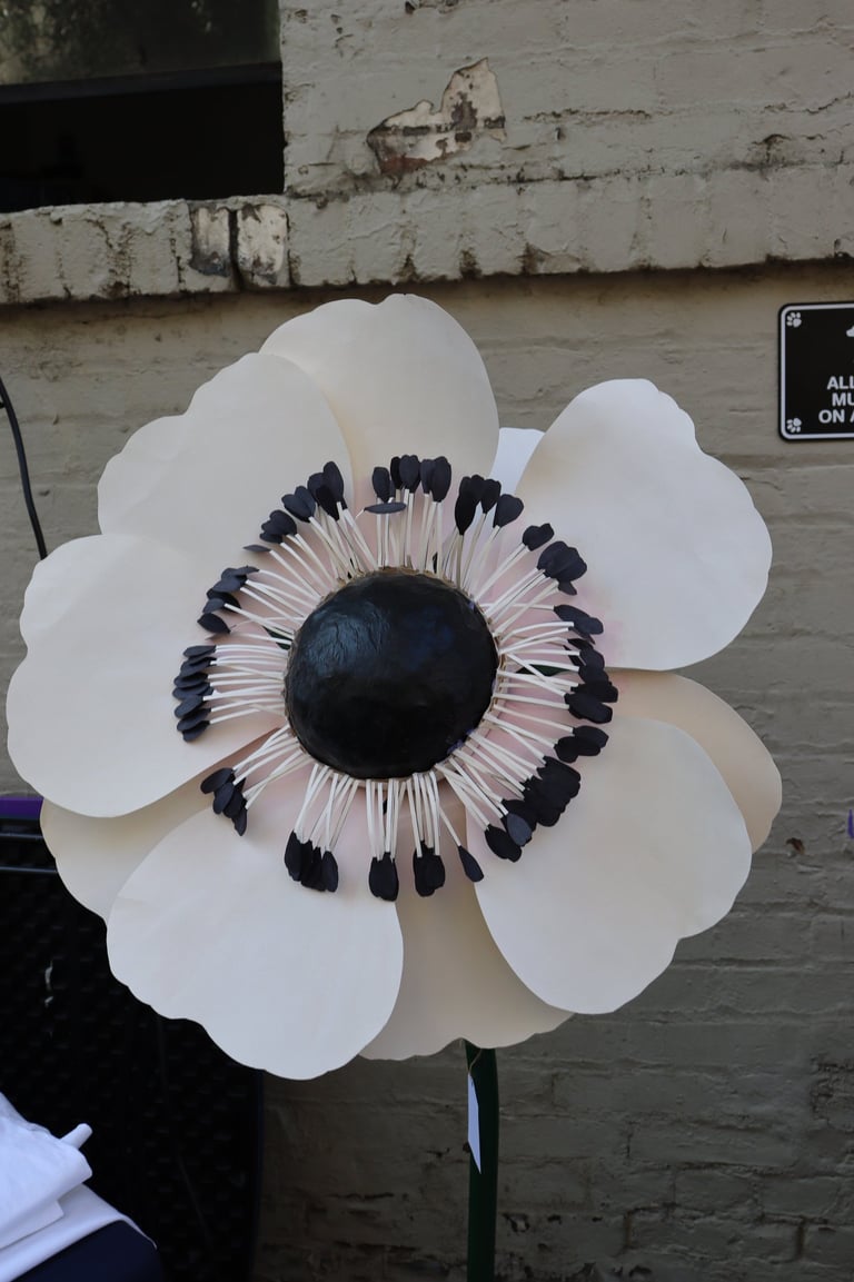 a paper flower with black and white flowers