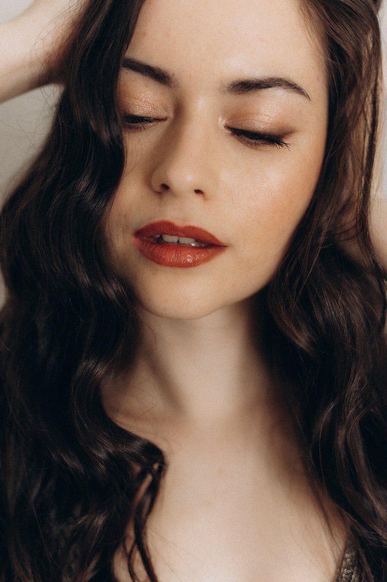 a woman with long hair and red lips.