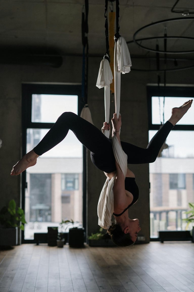 Girl hanging upside down on material