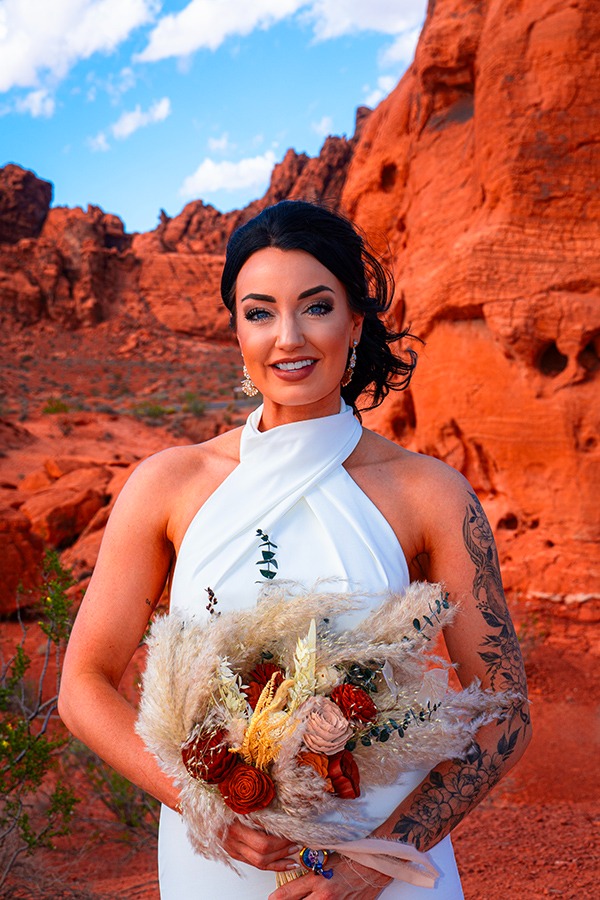 a woman in a white dress holding a bouquet