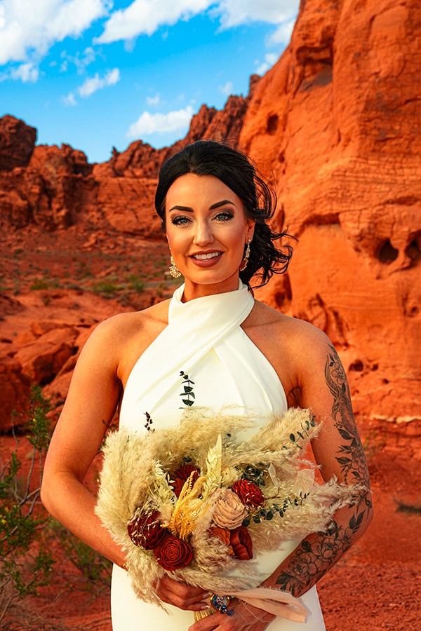 a woman in a white dress holding a bouquet