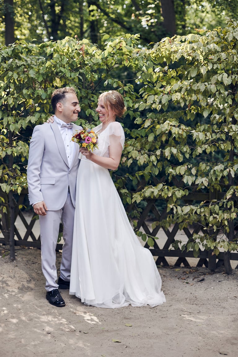Bride and groom looking at each other smiling.