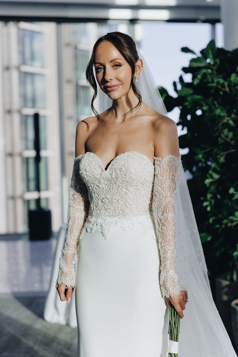 a bride in a white wedding dress with a veil