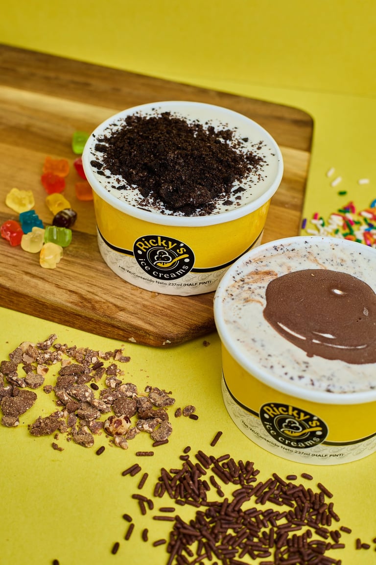 two cups of ice cream with chocolate chips and candy