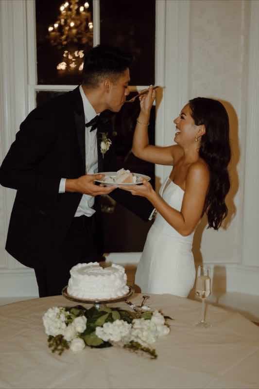 Couple cutting their wedding cake together