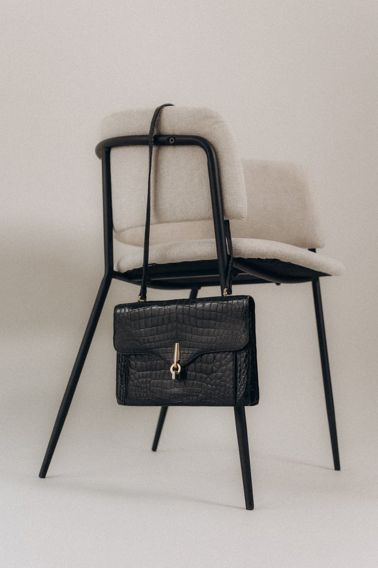 a chair with a purse and a purse bag