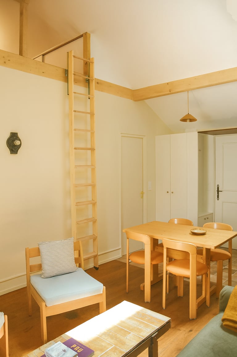 Renovated duplex in Pau with Charlotte Perriand table and Bruno Rey chairs