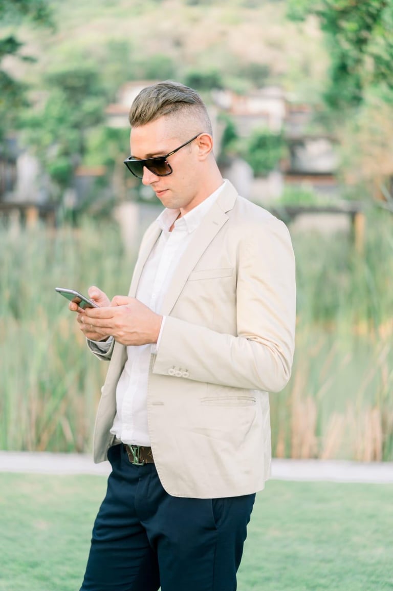 Francesco Margaretini Luxury Travel Villas Weddings working on the mobile phone