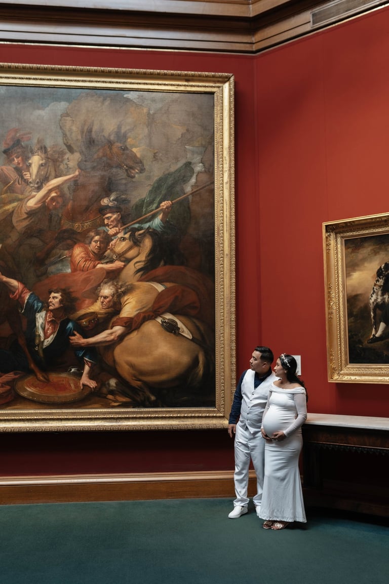 a man and woman standing in front of a painting