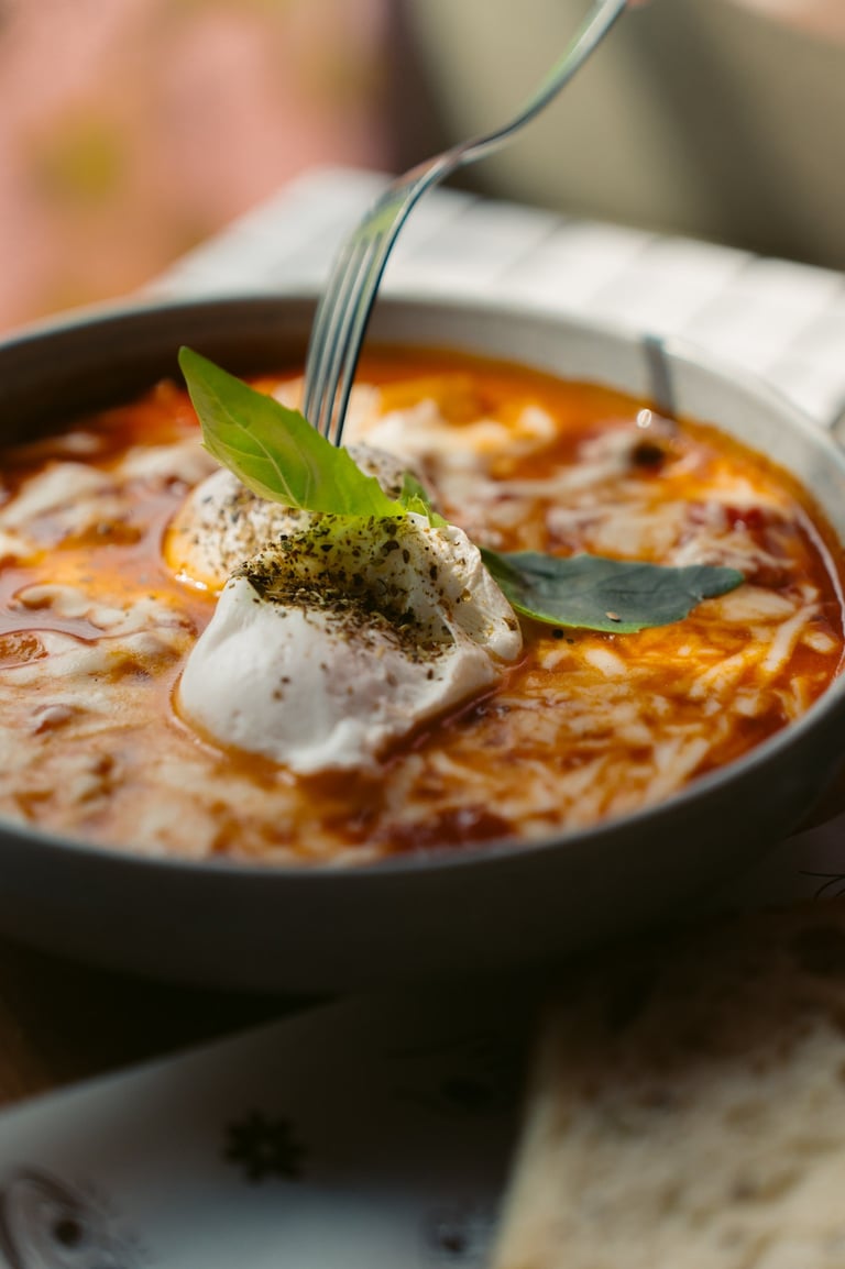 a bowl of soup with a fork and a fork