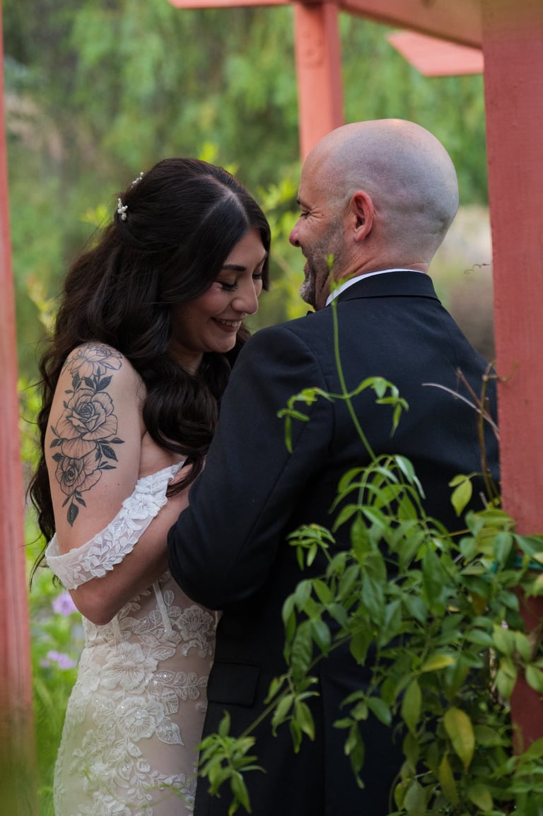 a man and woman standing in front of a gazeboar