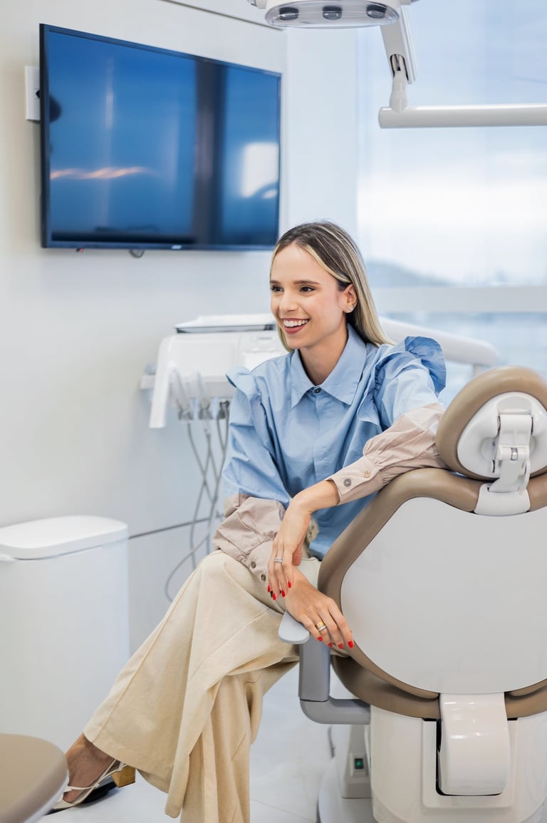 a woman in a dental chair with a smile on her face