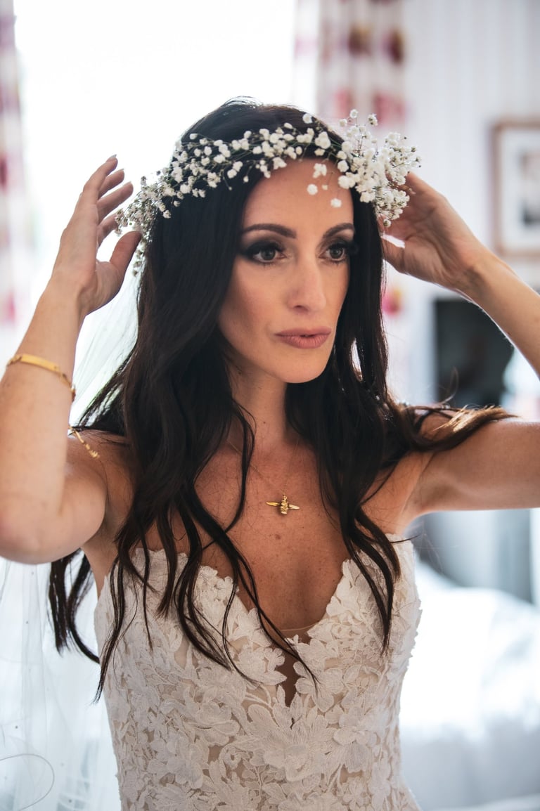 A bride in a wedding dress in full hair & makeup