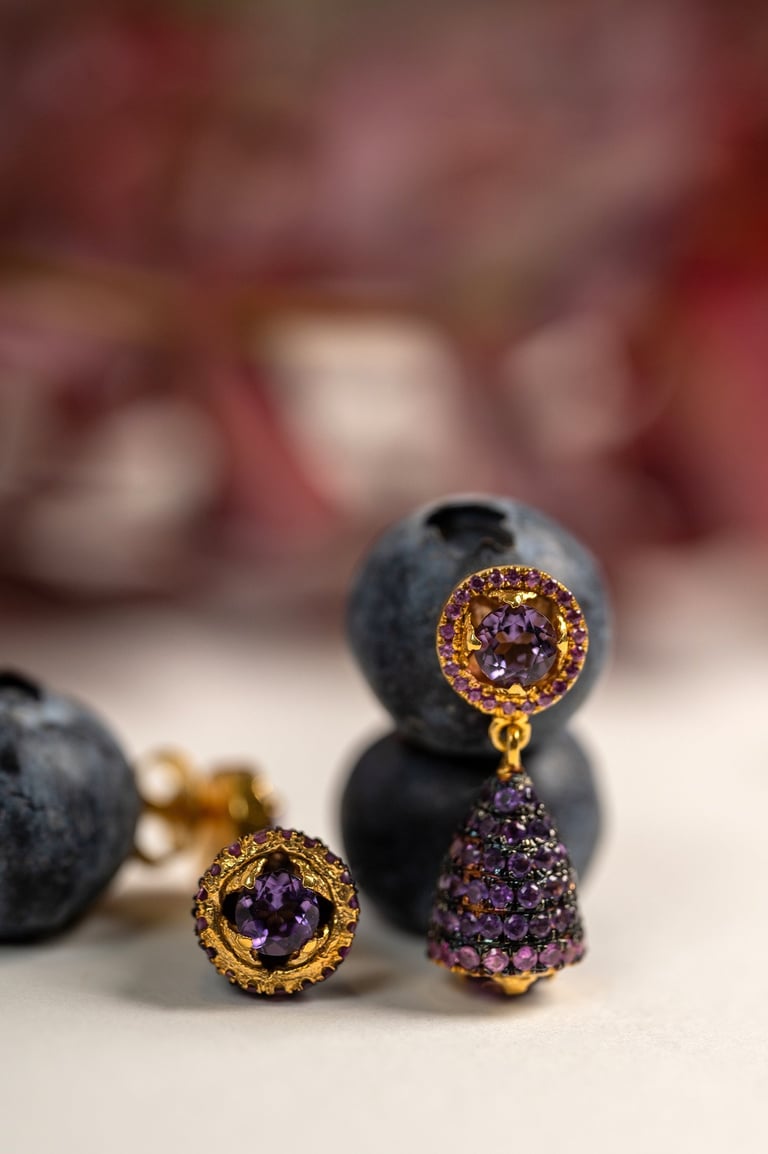 a bunch of blueberries and a pair of earrings