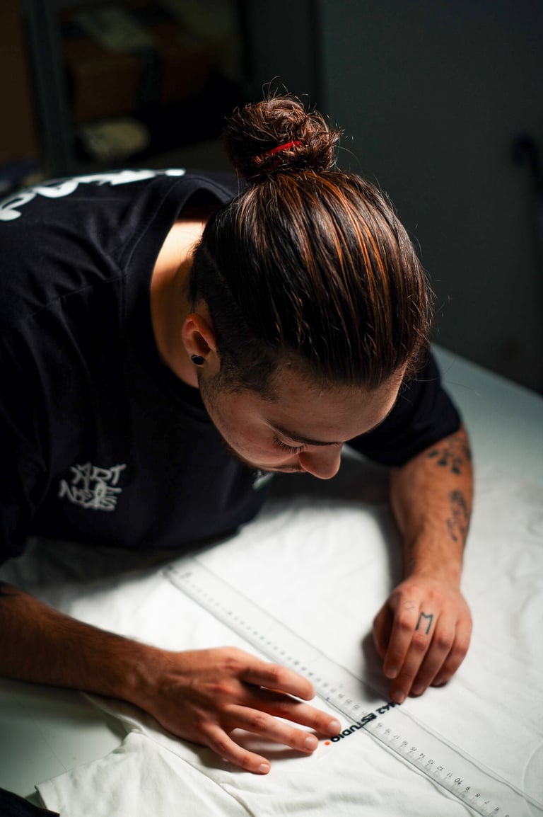 a man is looking down at a white sheet of paper