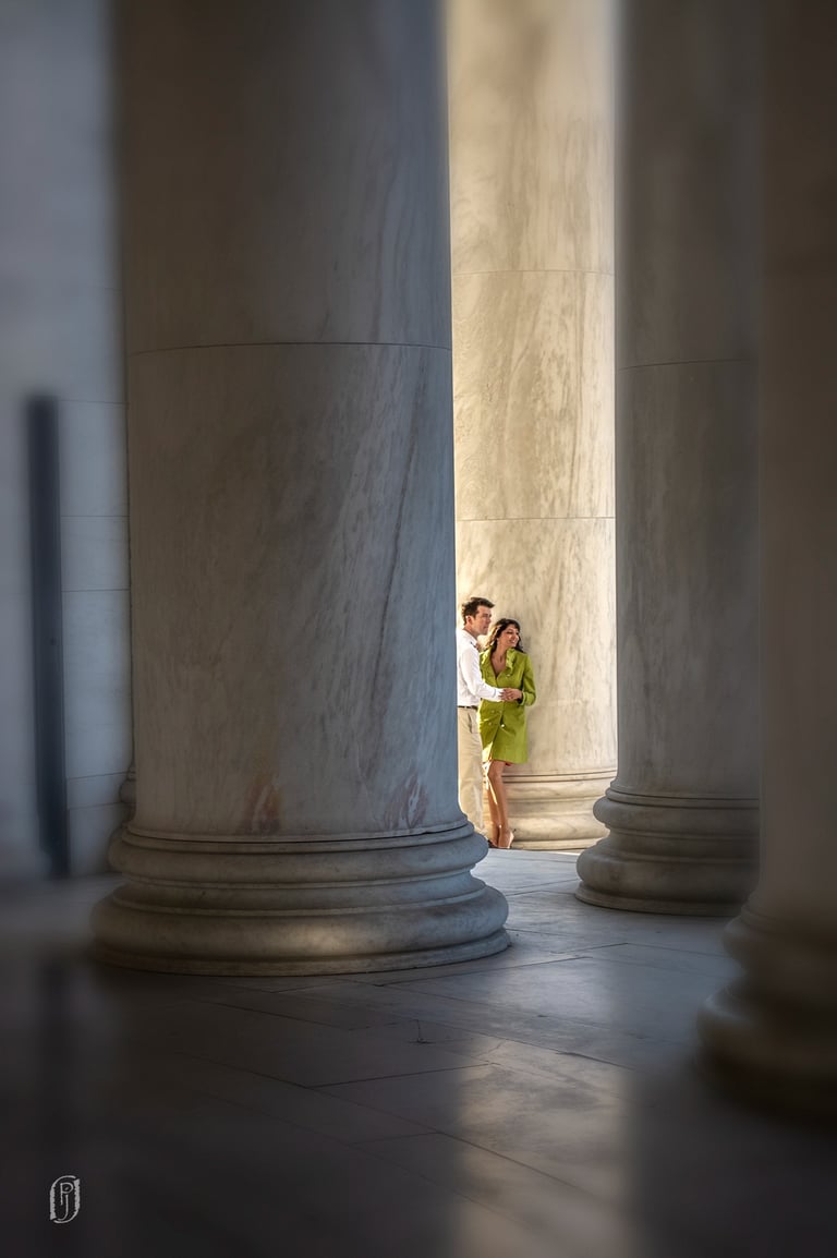 Photo of a couple seen between large columns