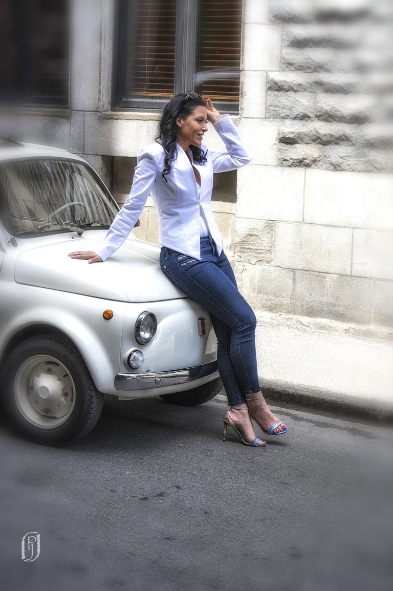 Photo of model leaning against car