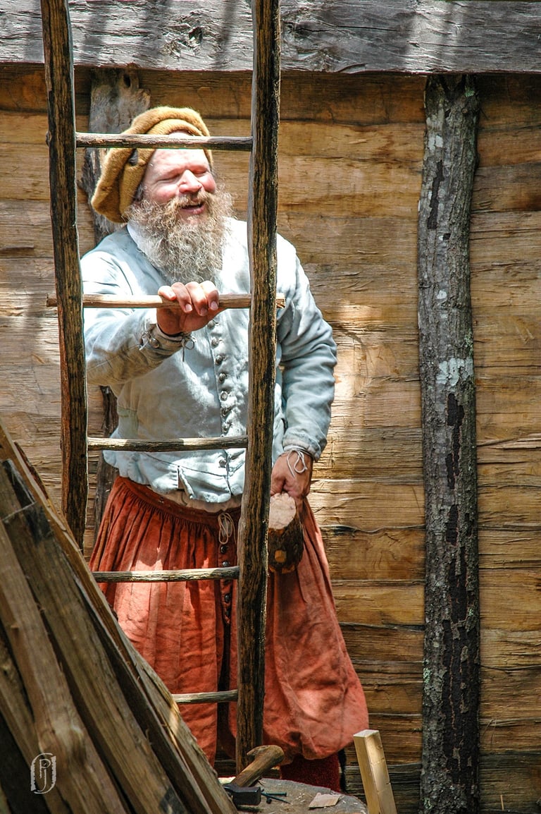 Photo of man at ladder from early American settlement
