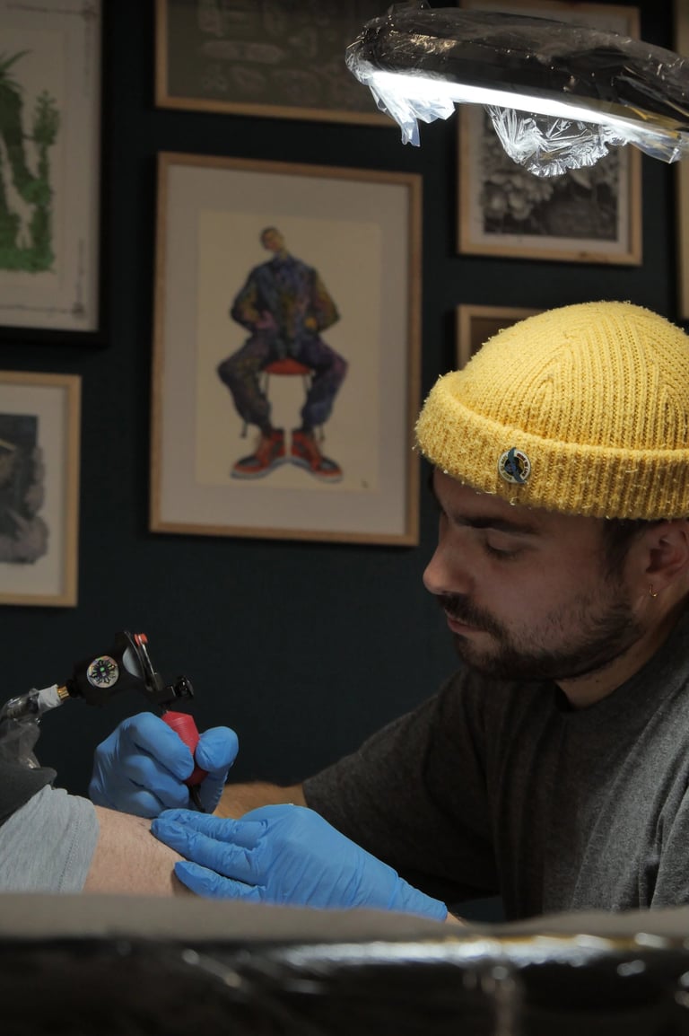 jeune tatoueur entrain de travailler
