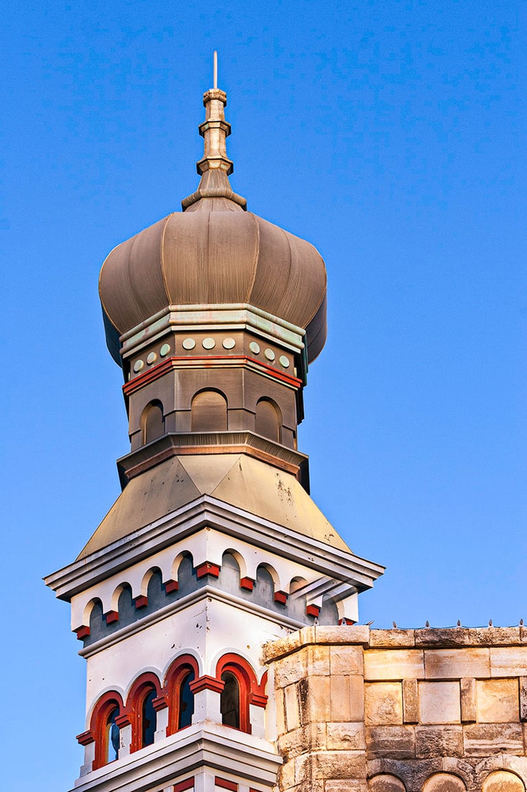 Historic Georgetown, Texas building featuring iconic onion dome architecture under a bright blue sky.