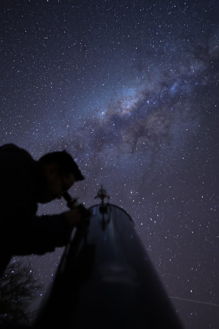 a man is looking at the stars in the sky