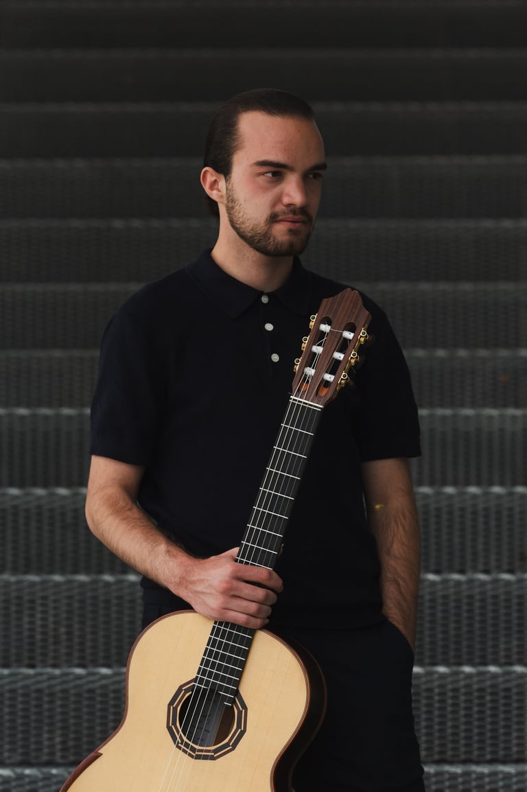Classical guitarist Filip Babic standing with the guitar casual