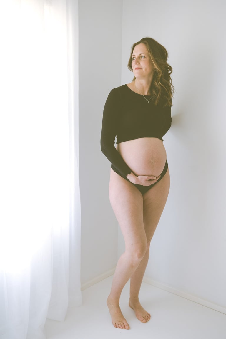maternity photo taken in Adelaide studio, mother looking out the window