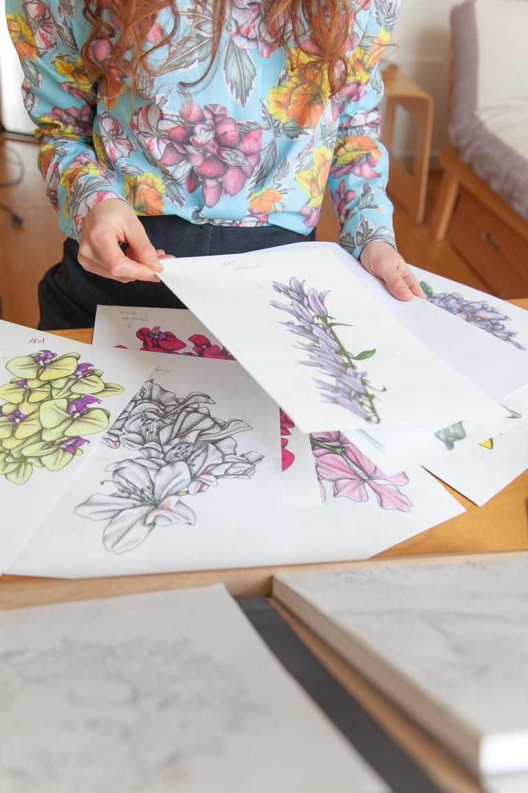 A desk filled with botanical illustrations