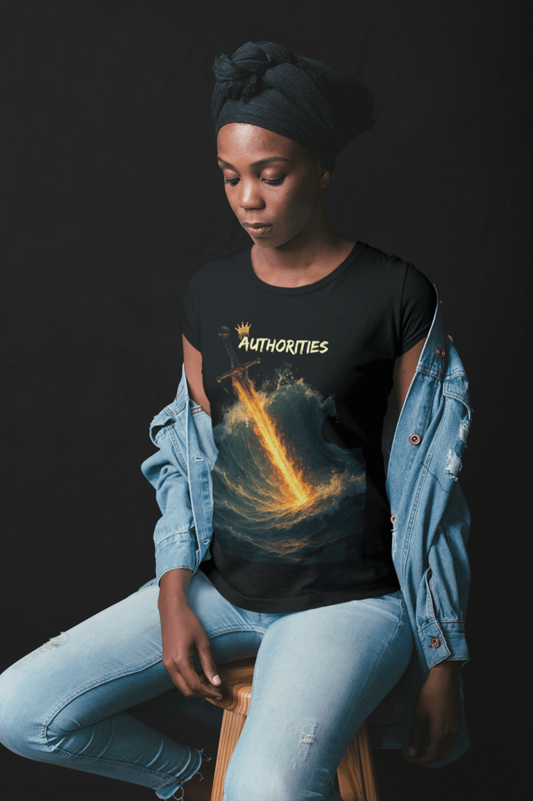 Woman wearing black t-shirt with flaming sword cutting through ocean waves and the word "AUTHORITIES