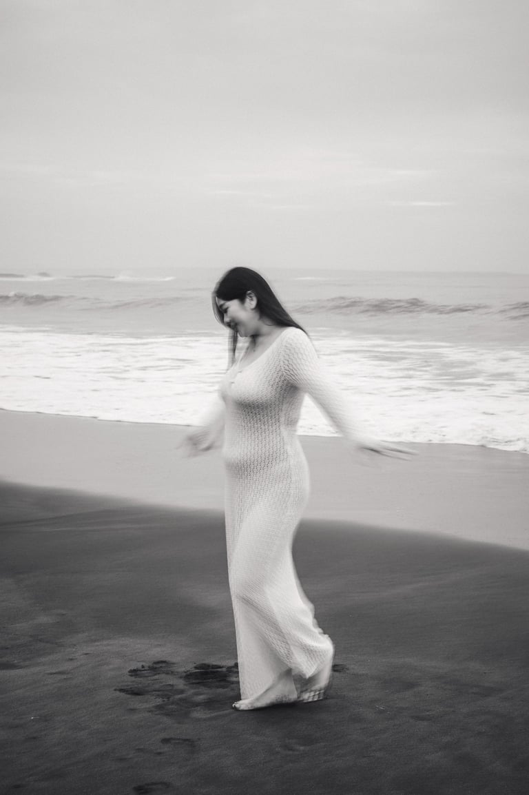 candid couple photography on black sand beach in Bali  ⸻