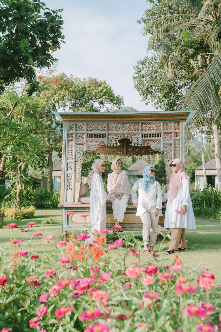 Group of friends walking near flower garden during photoshoot at Candi Beach Resort Karangasem Bali