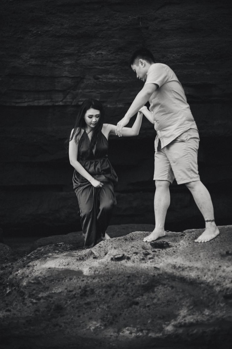 Artistic intimate couple portrait on rocks at Pantai Nyanyi Bali.