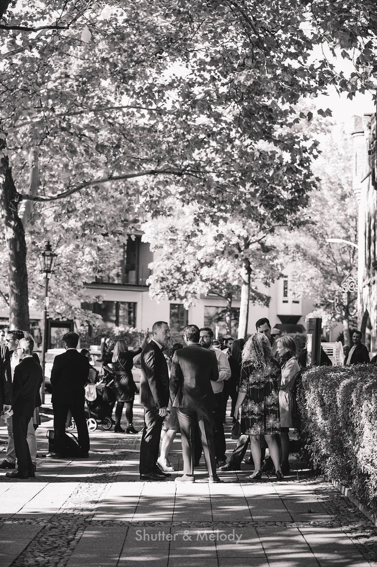 Wedding guests waiting for the ceremony to start outside..