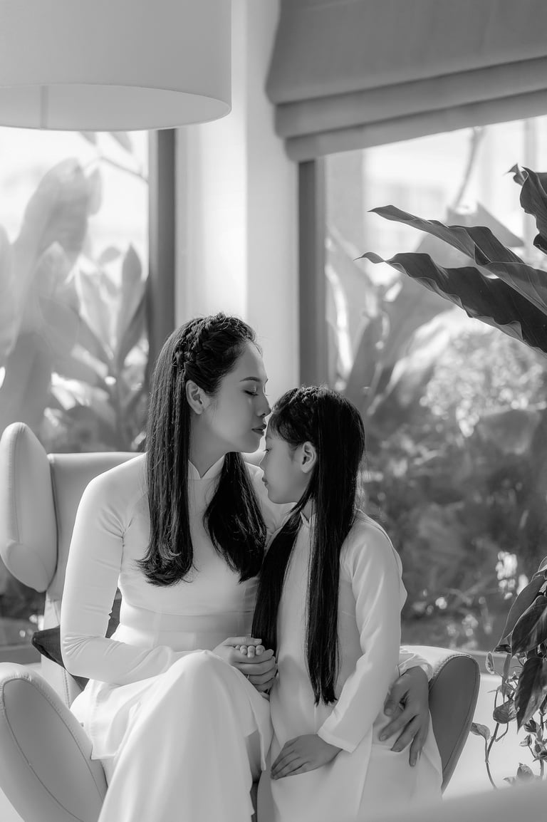a mother and daughter kissing in a living room