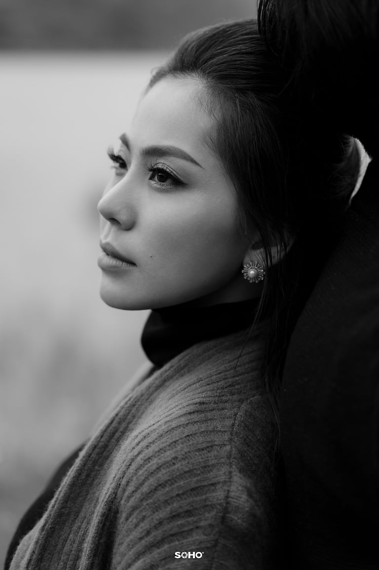 a woman with a ponytail hairstyled in a black and white photo