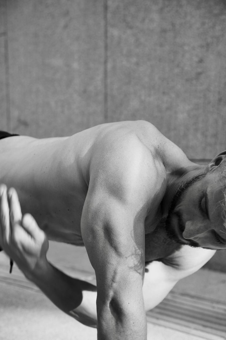 a man in a black and white photo doing rotational plank
