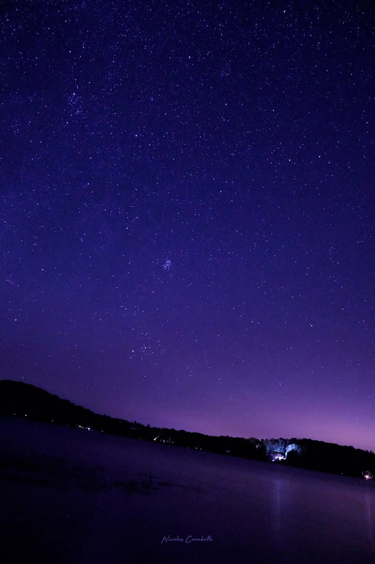 a boat is floating in the water at night