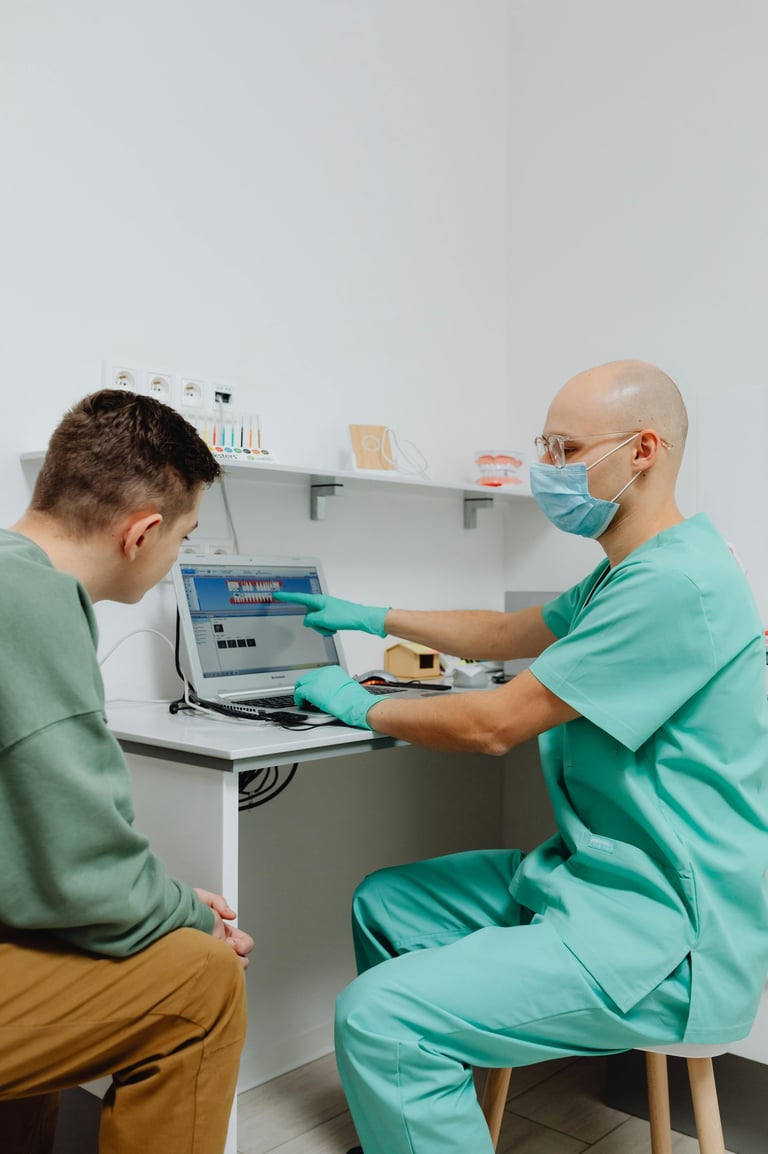 A doctor showing a patient results on a computer.