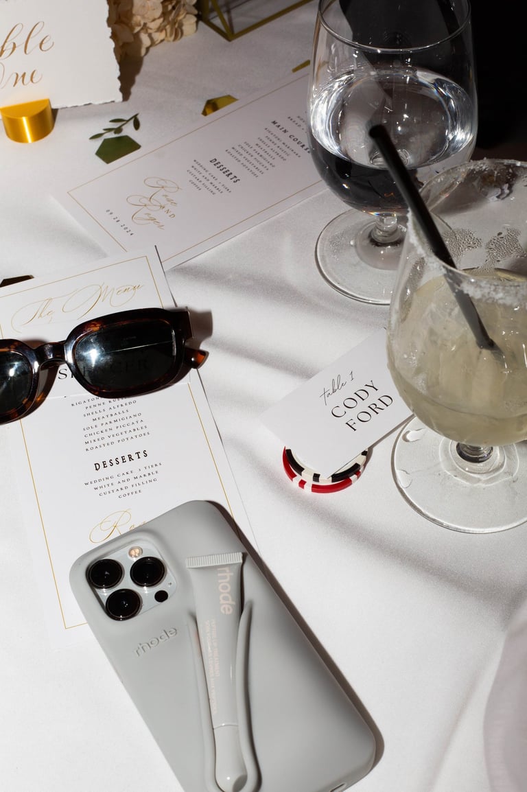 a wine glass and sunglasses on a table