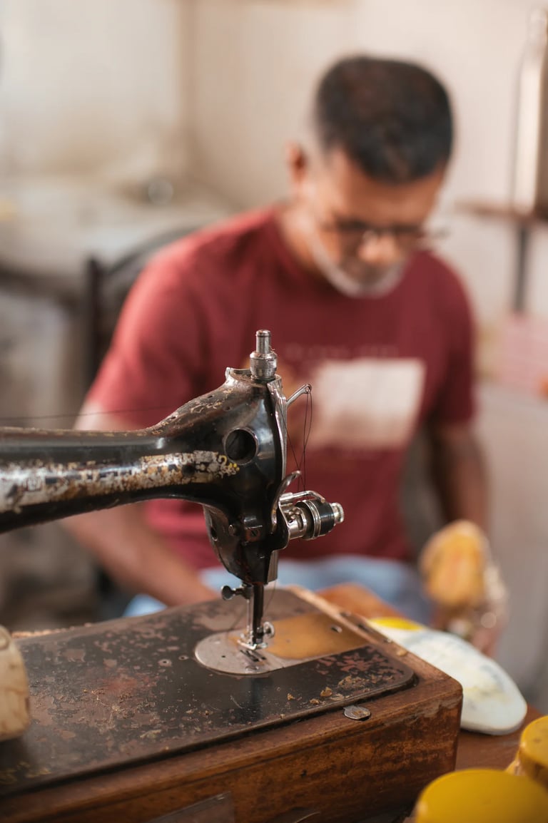 Vintage Singer sewing machine in cobbler workshop, Mahebourg Royal Road, Mauritius