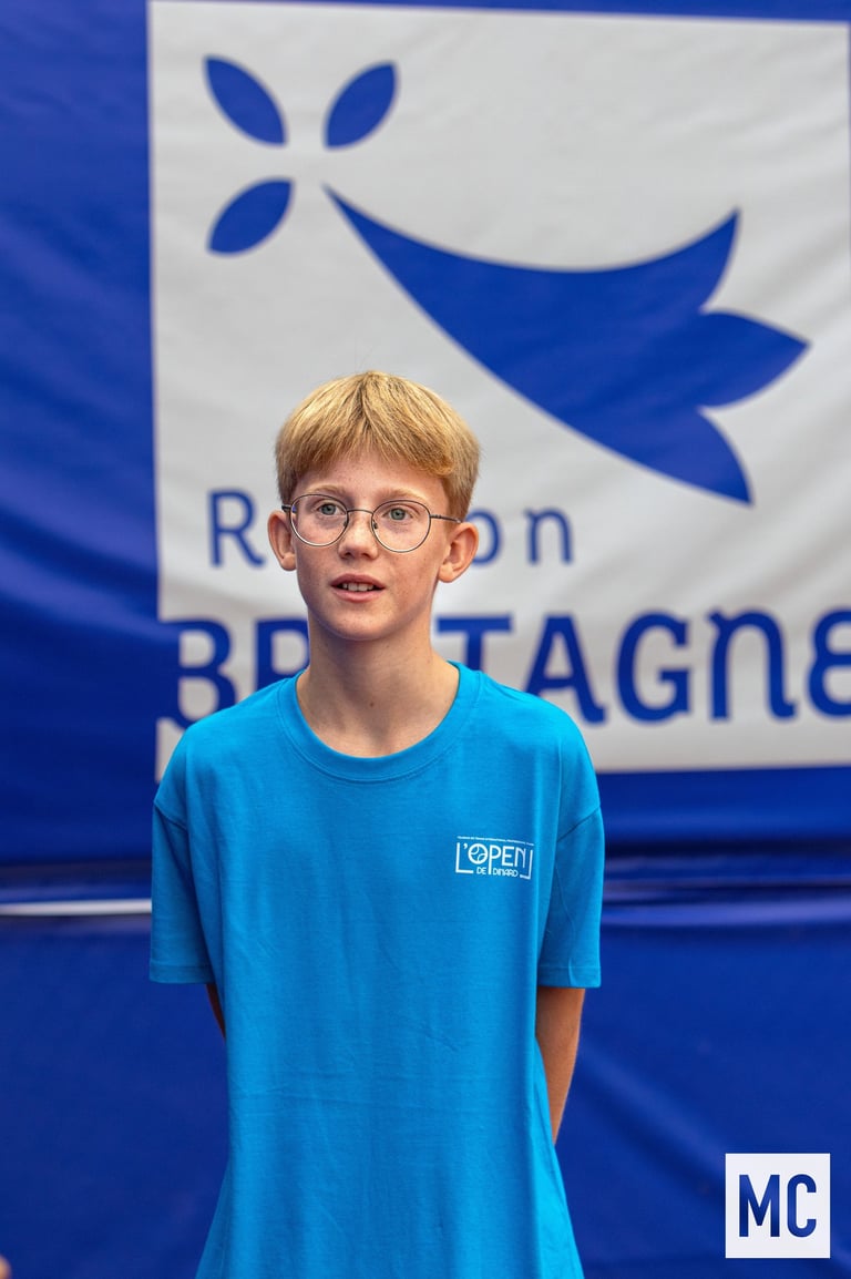 a young boy in a blue shirt and glasses