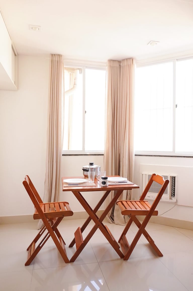 a table with chairs and a table with a cup of coffee