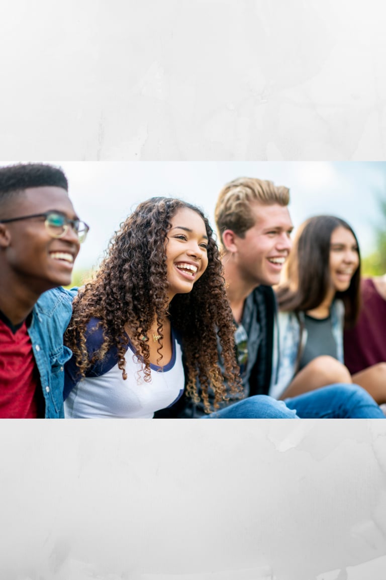 Group of happy teenage friends laughing together outdoors, showing confidence and strong friendships