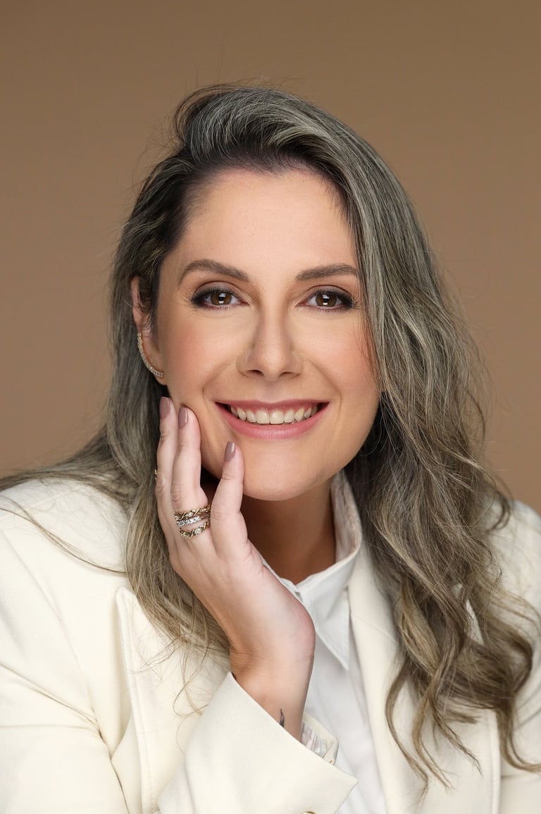 a woman with long hair and a white jacket