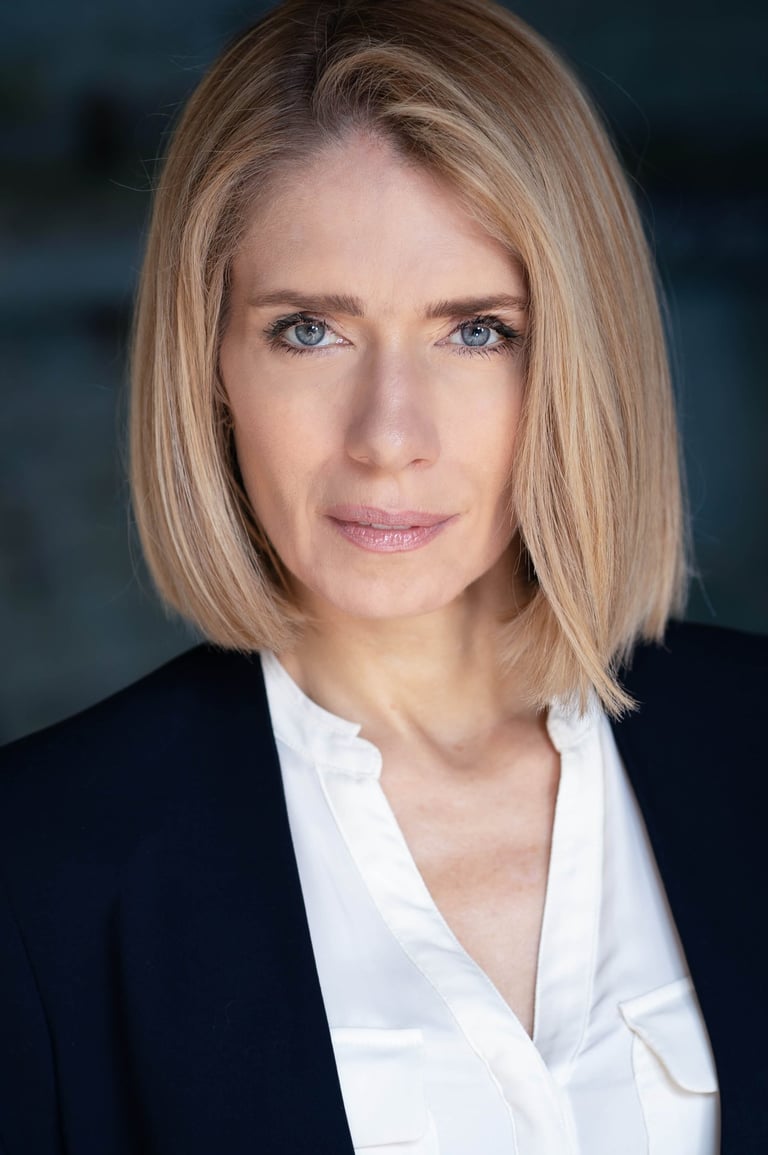 a woman with blonde hair and a white shirt