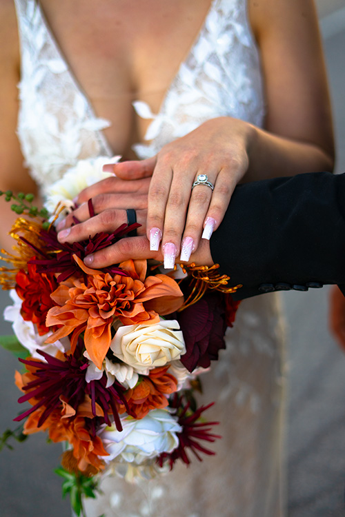 a bride and grooms hands with their wedding rings