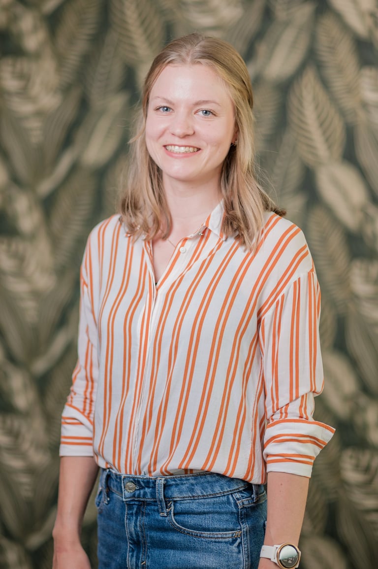 a woman in a striped shirt and jeans