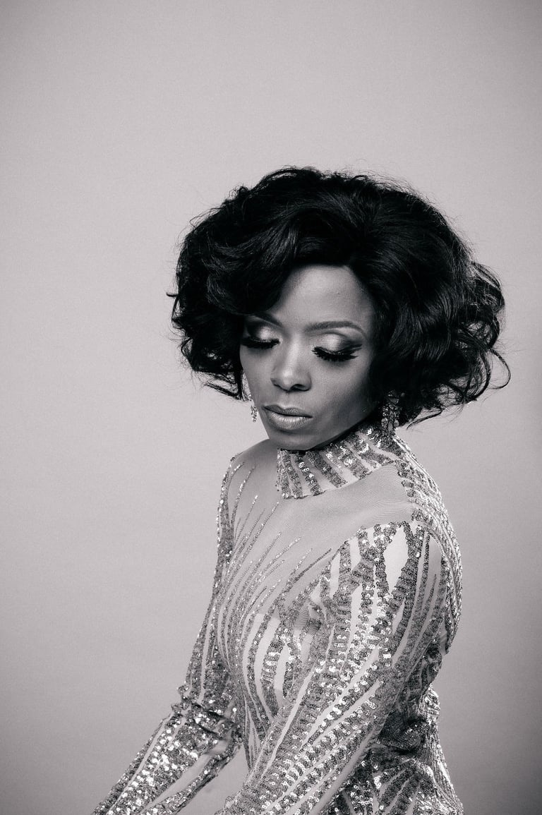 a woman in a sequinous dress with a large hairdo