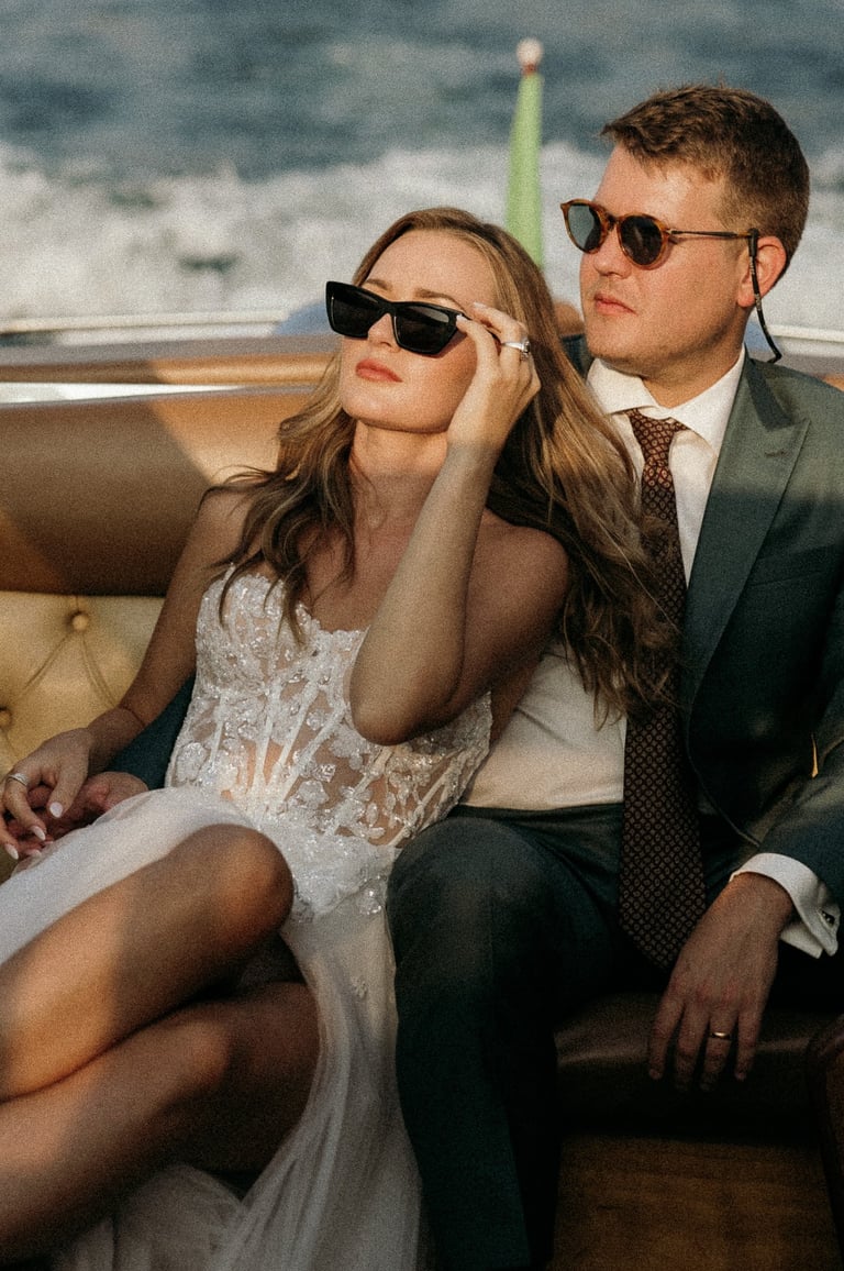 a man and woman sitting on a boat on Lake Como