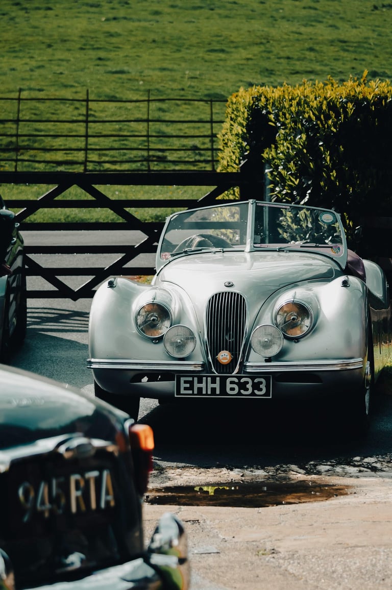 Image of British classic cars in driveway